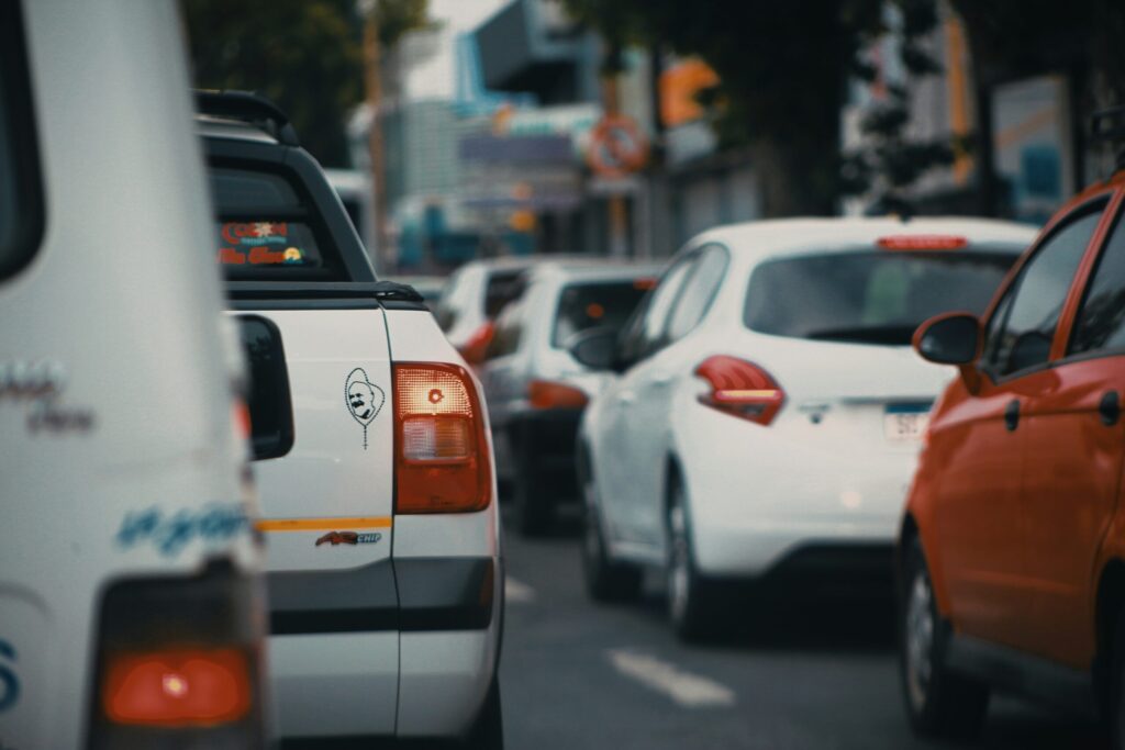 white and orange car on a road during daytime