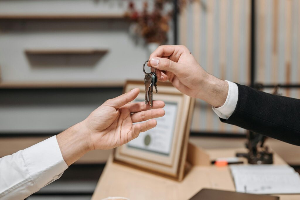 a person handing over the keys